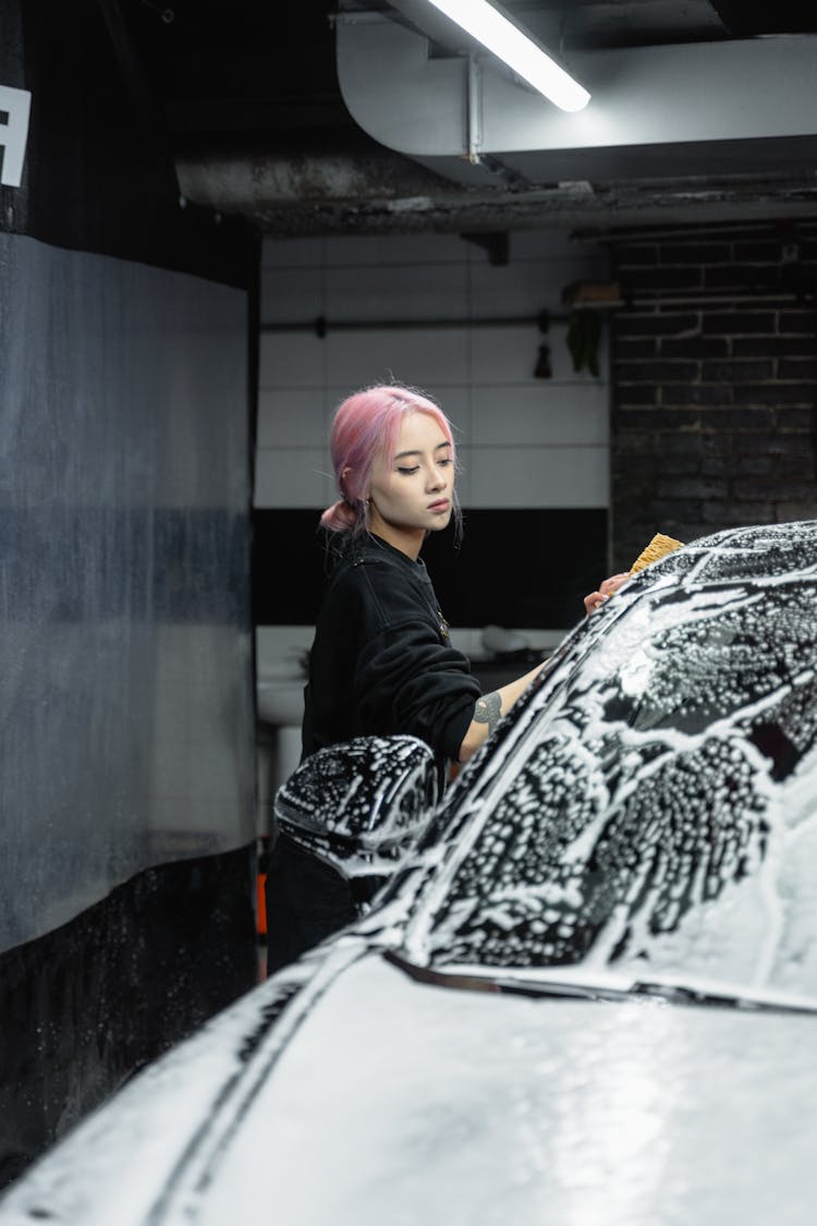 Woman With Pink Hair Cleaning A Car 