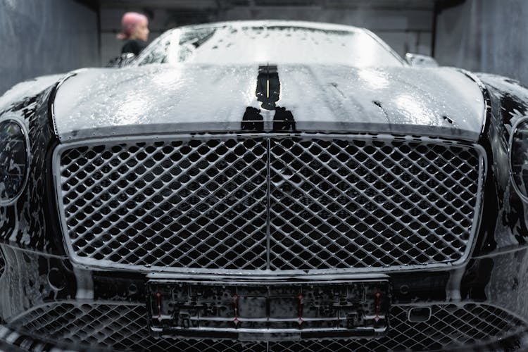 A Black Car Covered With Soap