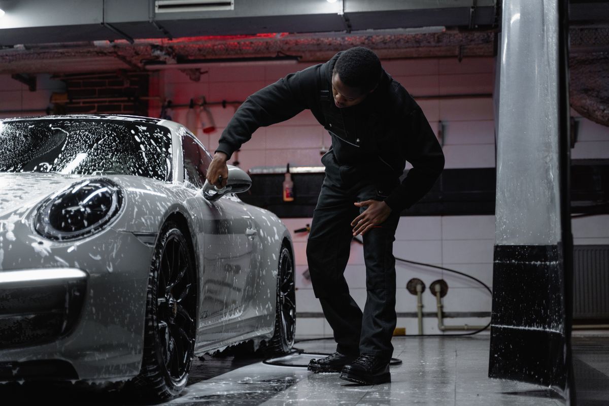 Subscription washer detailing a member's car at home