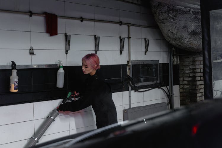 A Woman Using Power Tools In The Garage