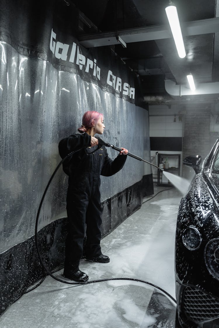 A Woman Washing A Black Car