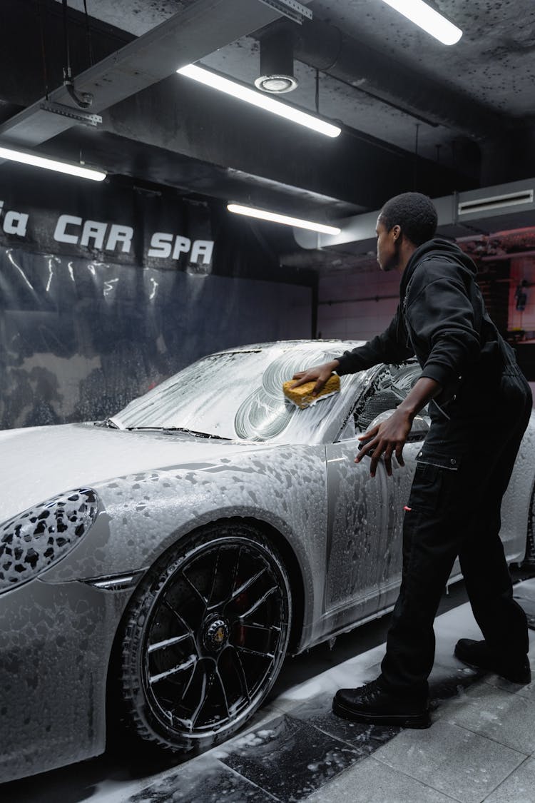 A Man Washing A Car