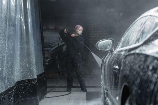 Man in Black Coat Standing Beside Car
