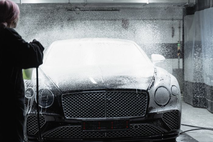 Luxury car covered in foam during a detailed wash