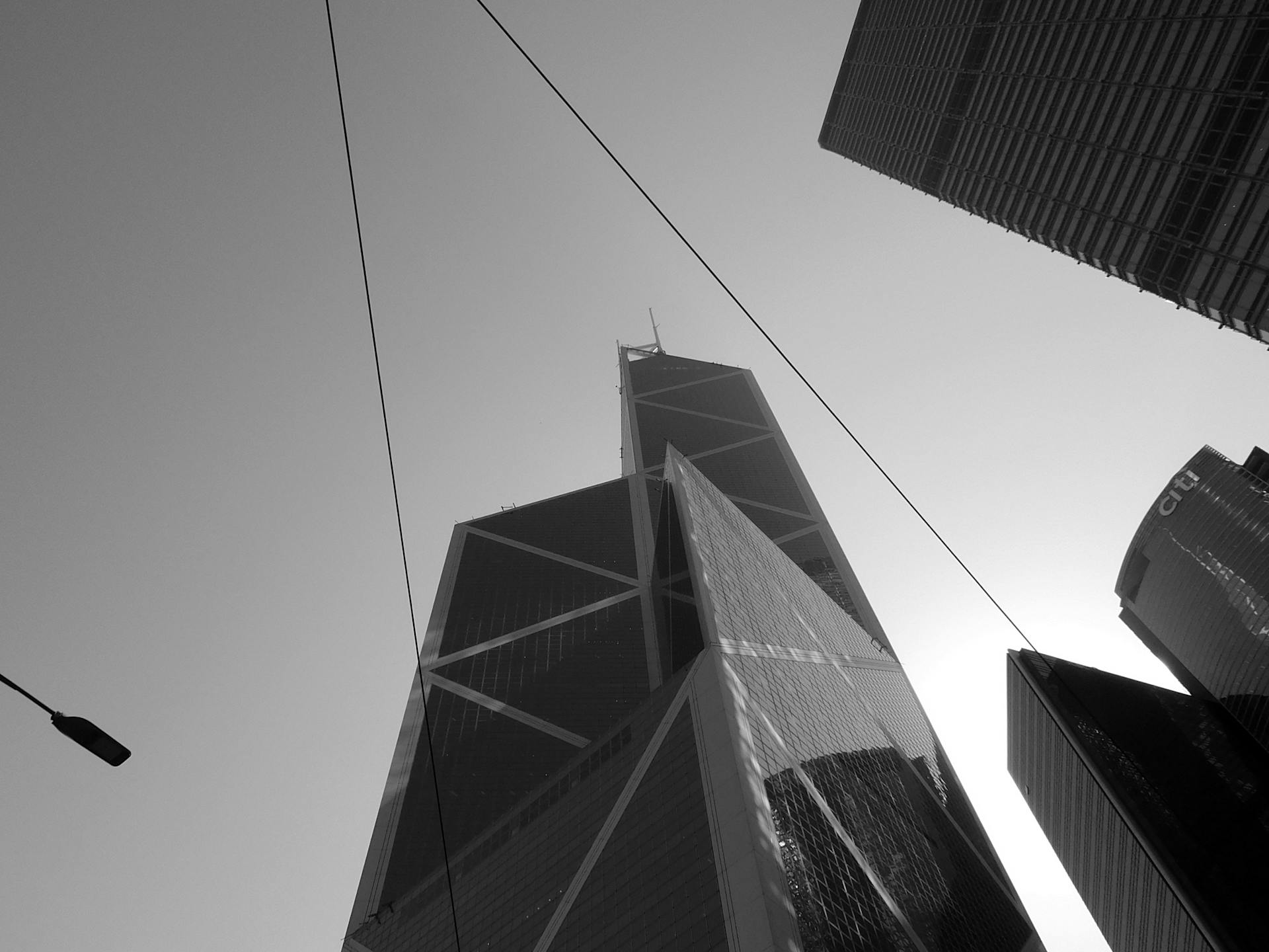 Black and white image of Hong Kong skyscrapers emphasizing geometry and modern design.