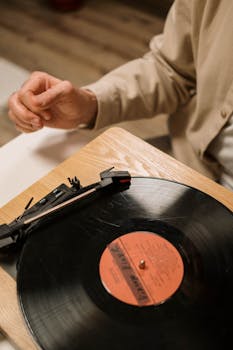 Vintage vinyl record playing on a wooden turntable, capturing nostalgic feel of classic music.