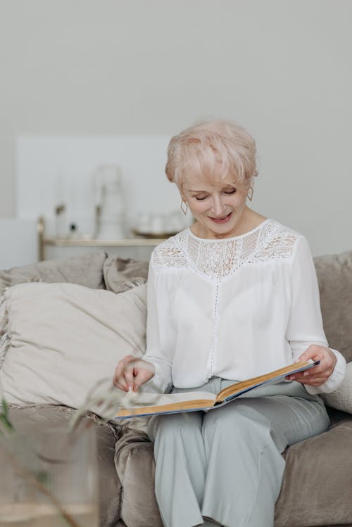 Photo of an Elderly Woman Reading a Book