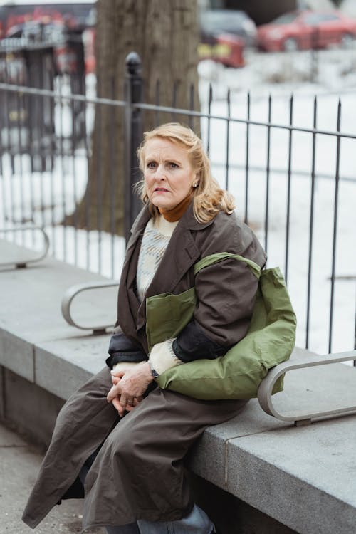 Free Amazed woman resting on bench in city Stock Photo