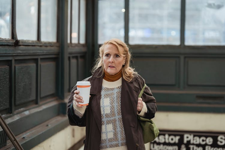 Scared Woman With Coffee To Go In Building