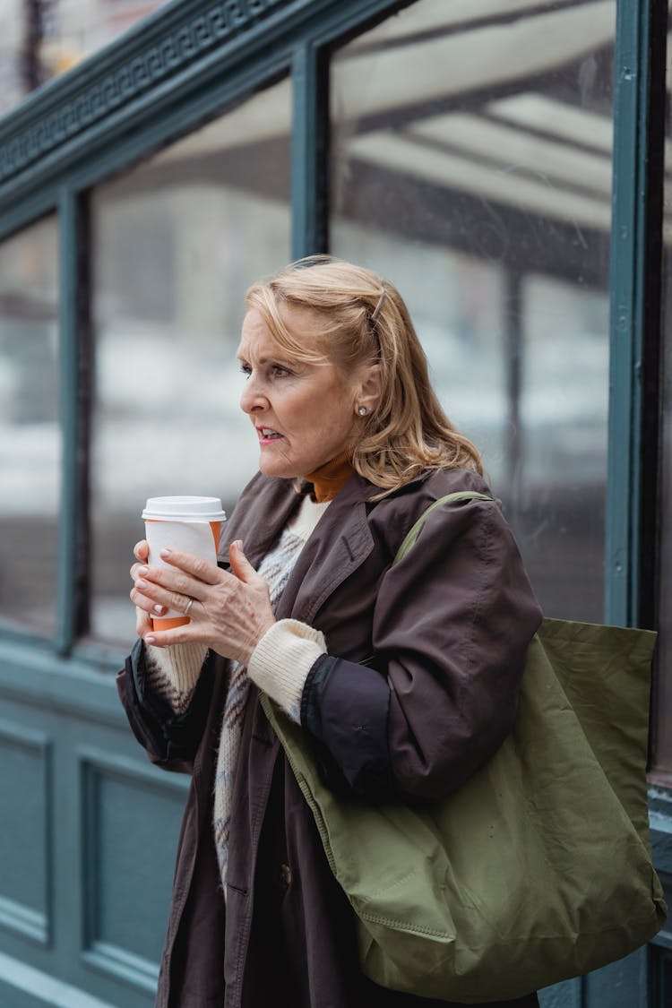 Elderly Woman With Coffee To Go On City Street