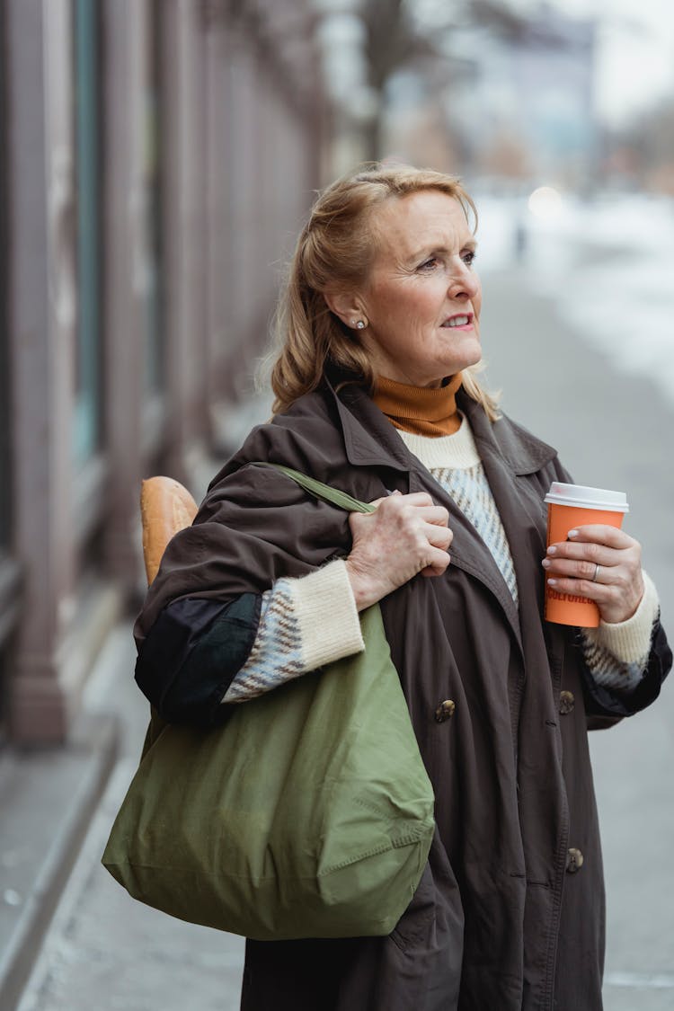 Dreamy Woman With Coffee To Go On City Pavement