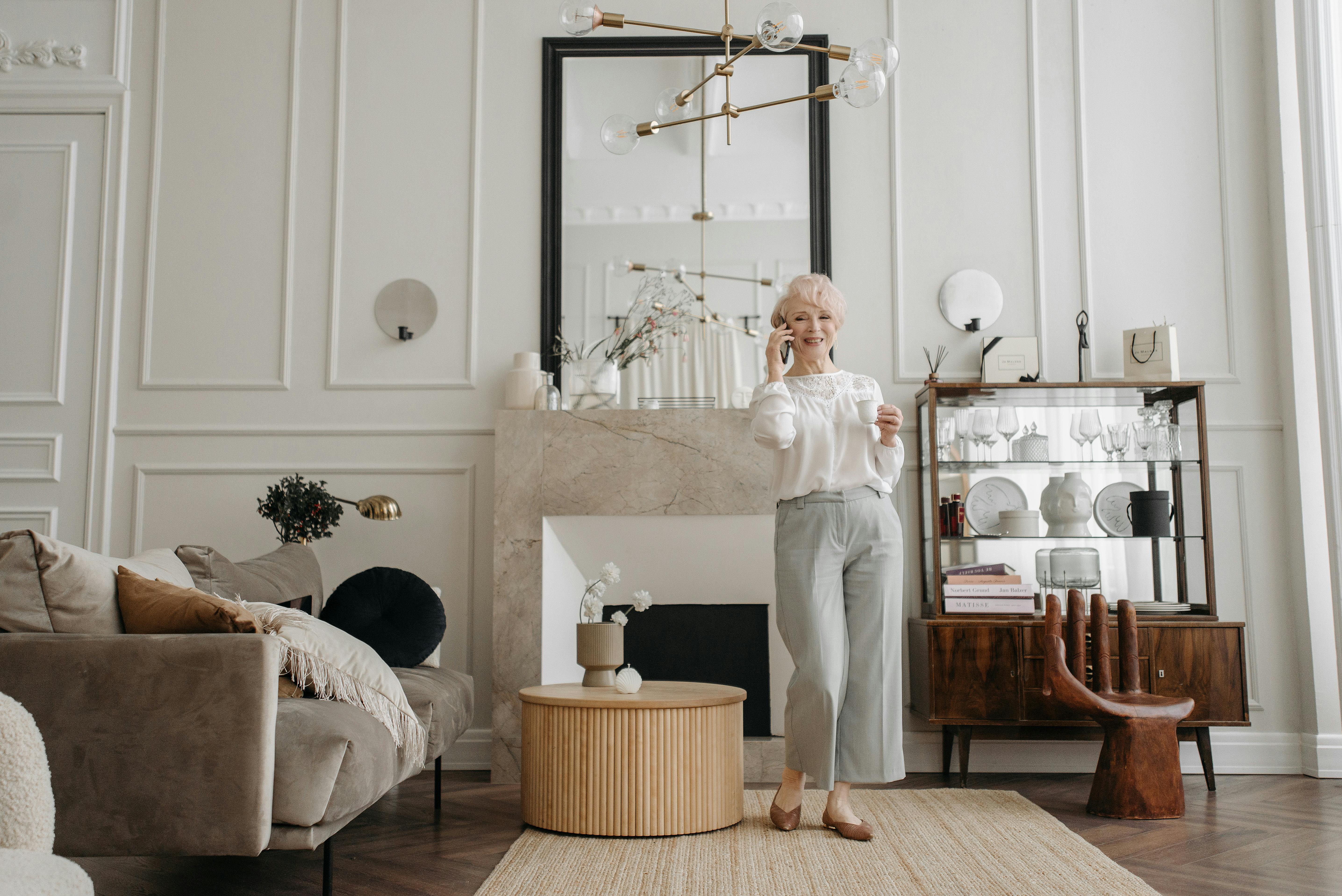 photo of an elderly woman in a white blouse talking on the phone