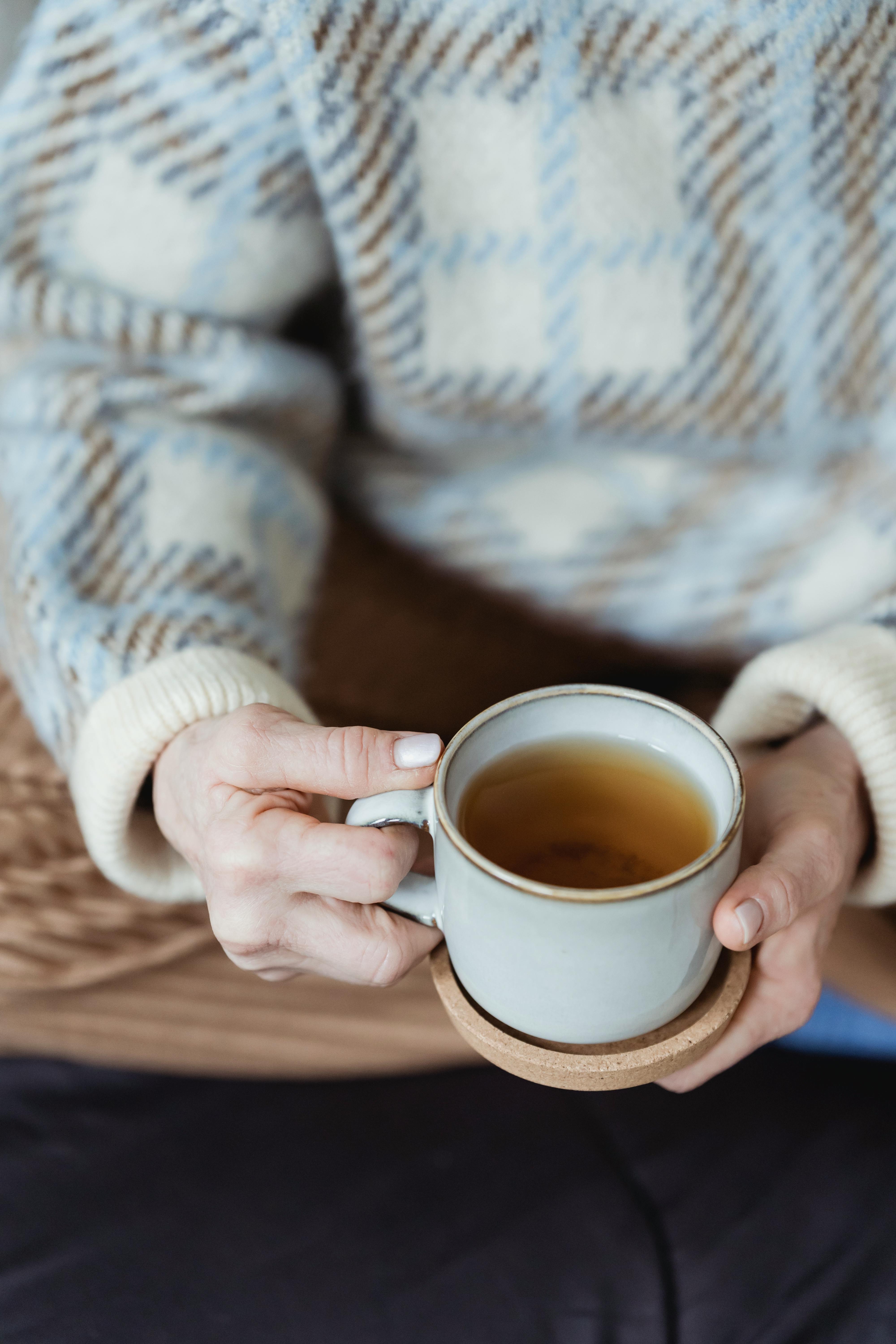 Crop woman pouring tea in cup · Free Stock Photo