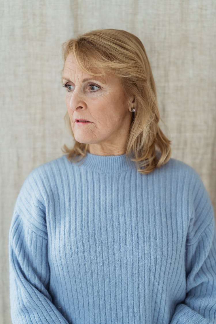 Calm Mature Stylish Woman Looking Away Pensively In Sunlight