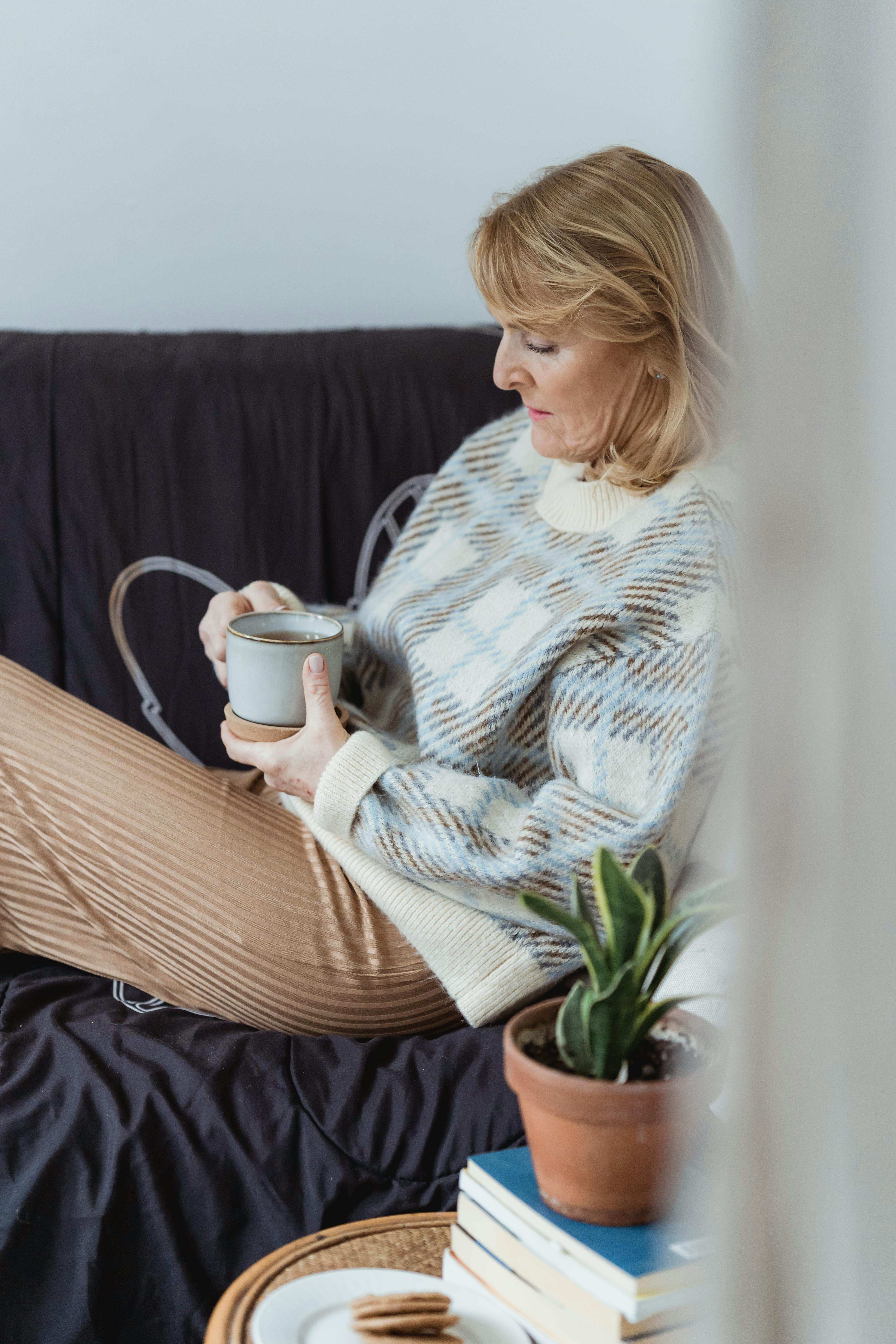 Middle aged woman relaxing on sofa feeling confident