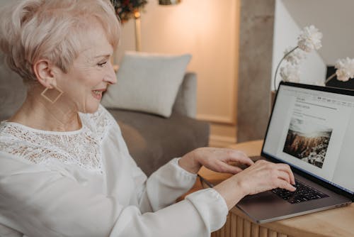 A Short Haired Woman Using a Laptop 