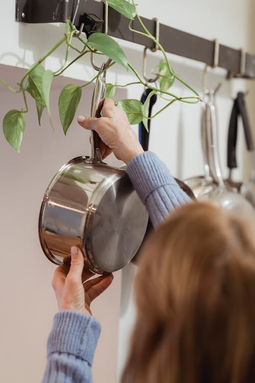 Free Person Hanging a Cooking Pot Stock Photo
