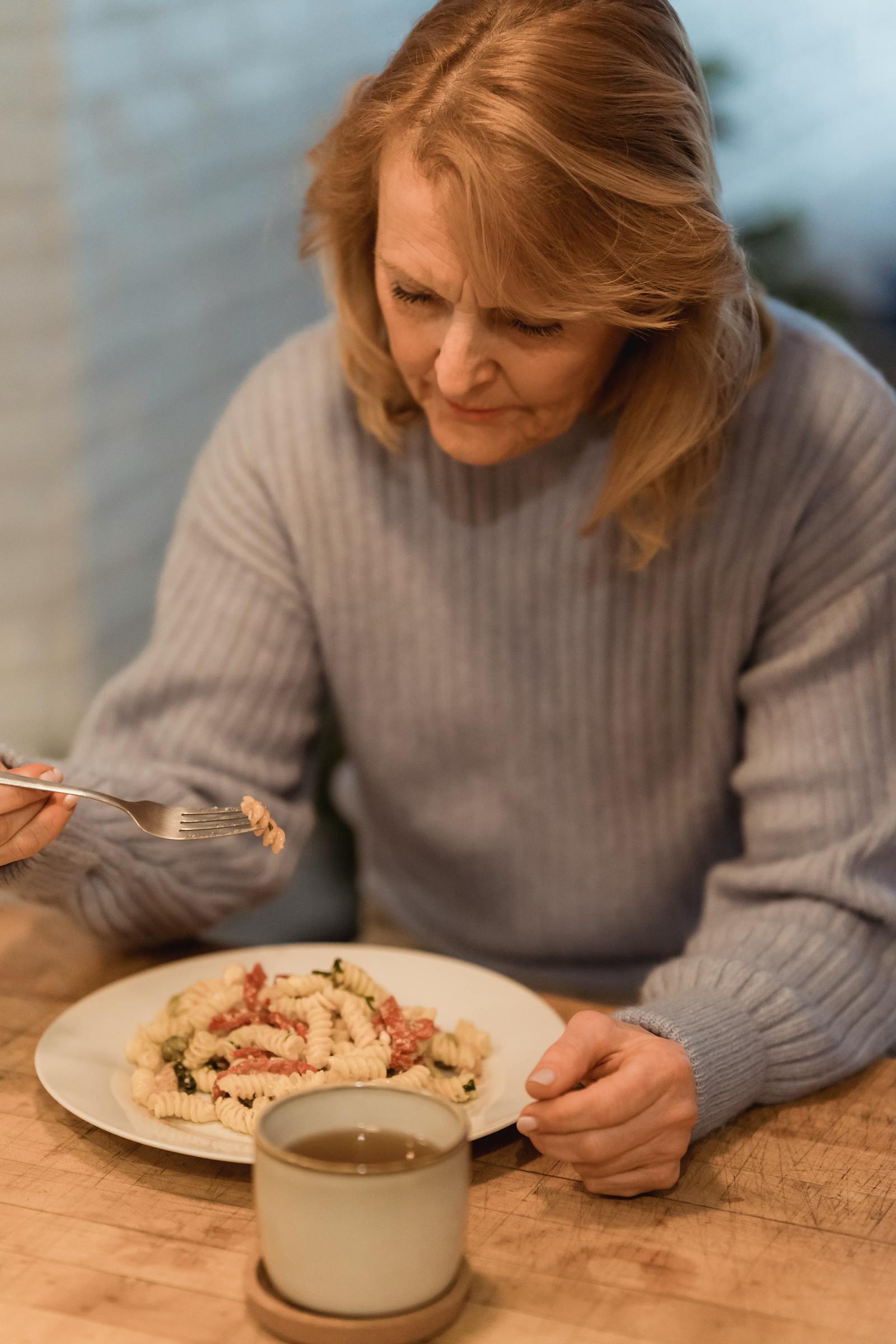 A senior looking disinterested in food. A guide to senior nutrition.