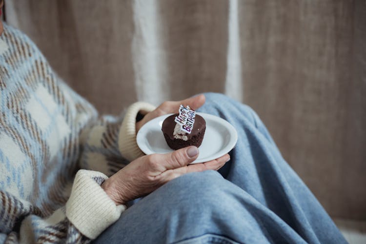 Crop Mature Woman With Tasty Muffin On Birthday