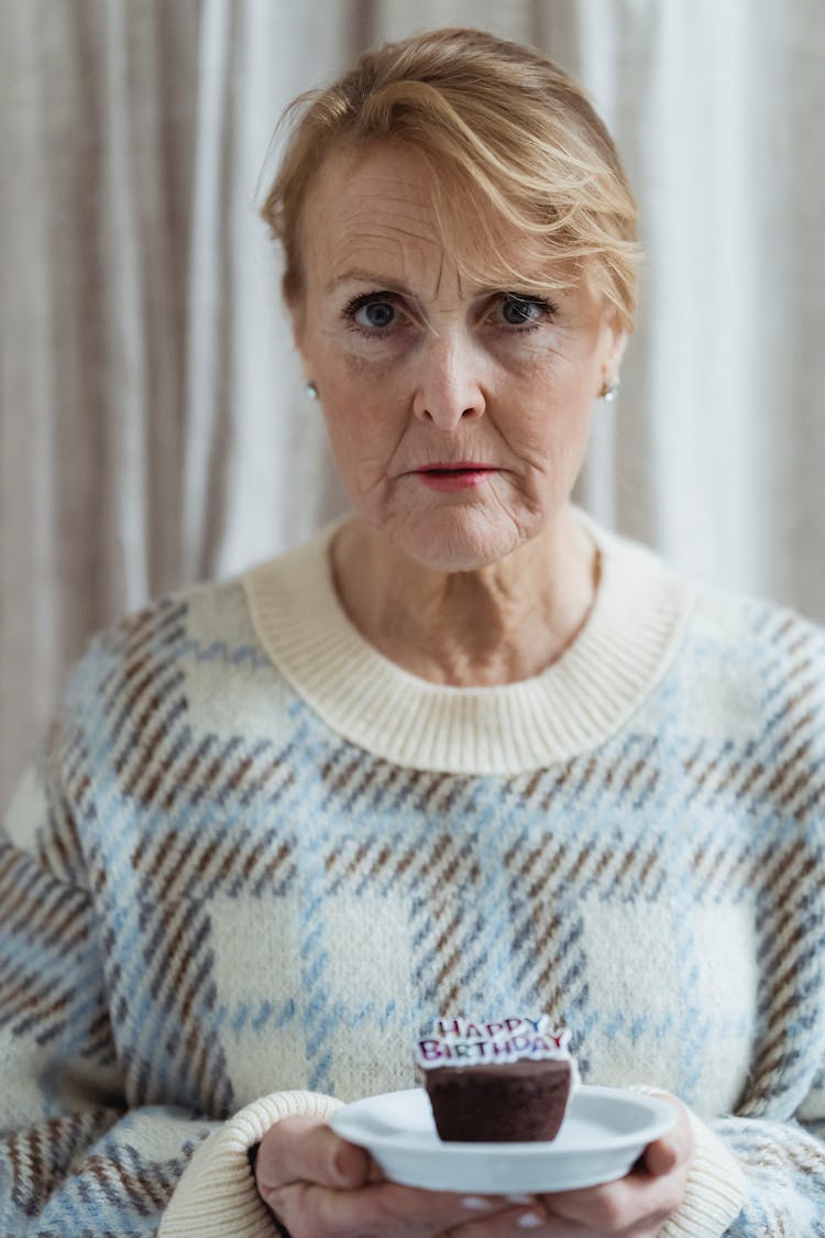 Mature Woman With Tasty Chocolate Muffin On Birthday