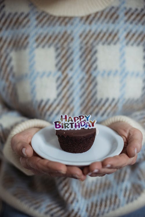 Free Chocolate Cupcake with a Birthday Decoration on Top  Stock Photo