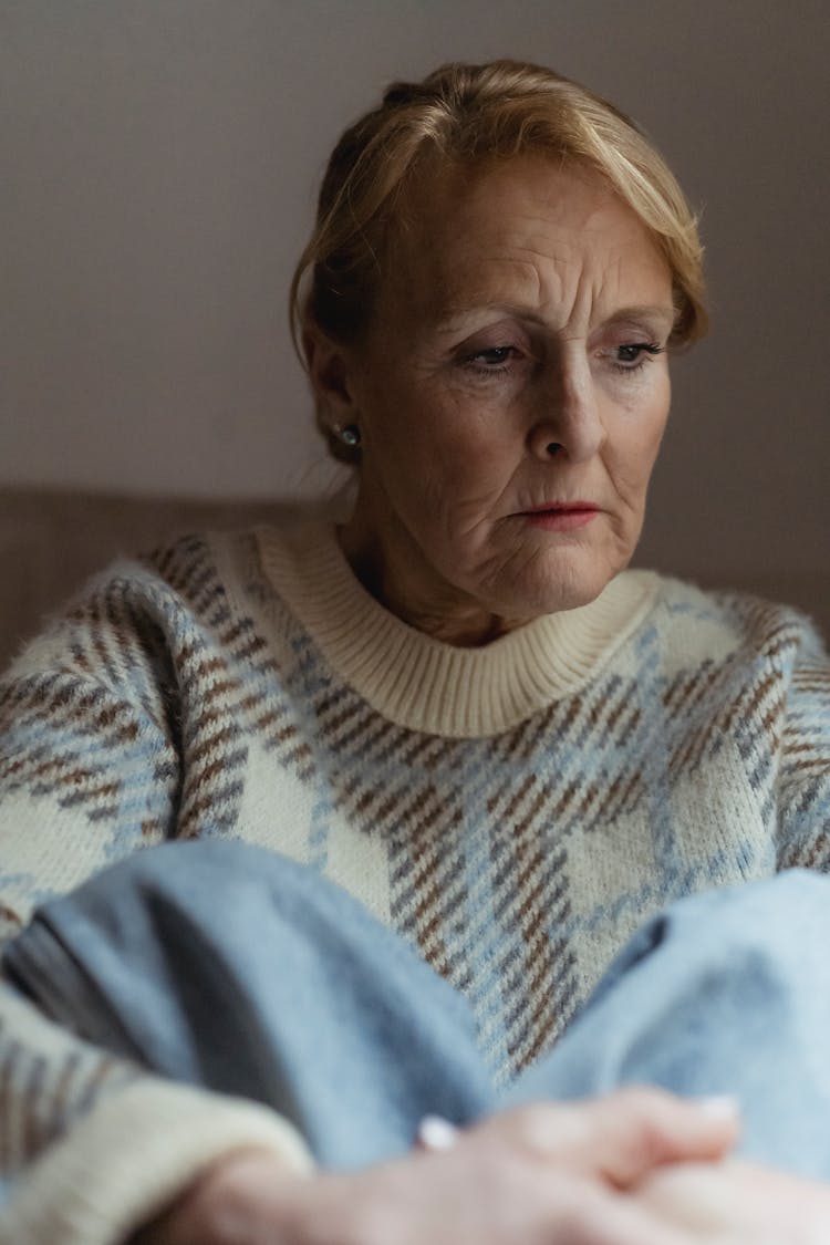 Contemplative Mature Woman Looking Away In Deep Thoughts