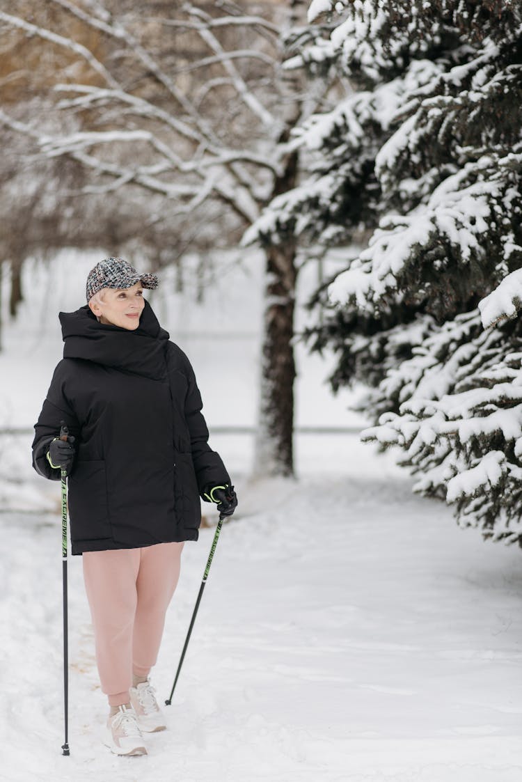 An Elderly Woman Hiking During Winter