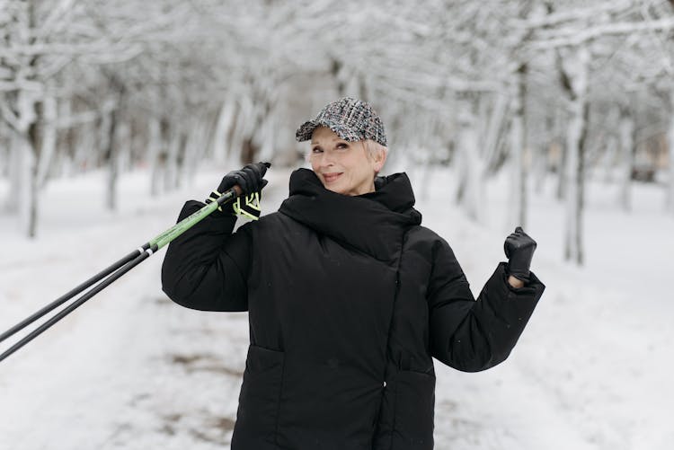 Man In Black Winter Jacket Holding Ski Poles