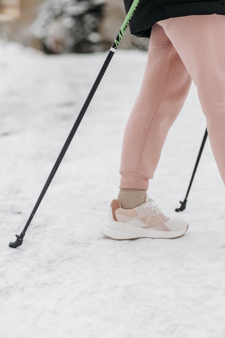 A Person's Leg Near A Trekking Pole