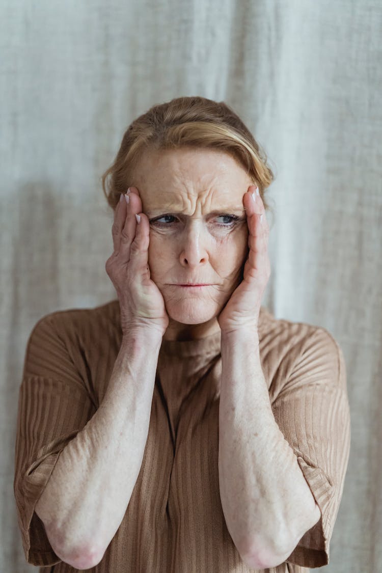 Unhappy Old Woman Touching Head