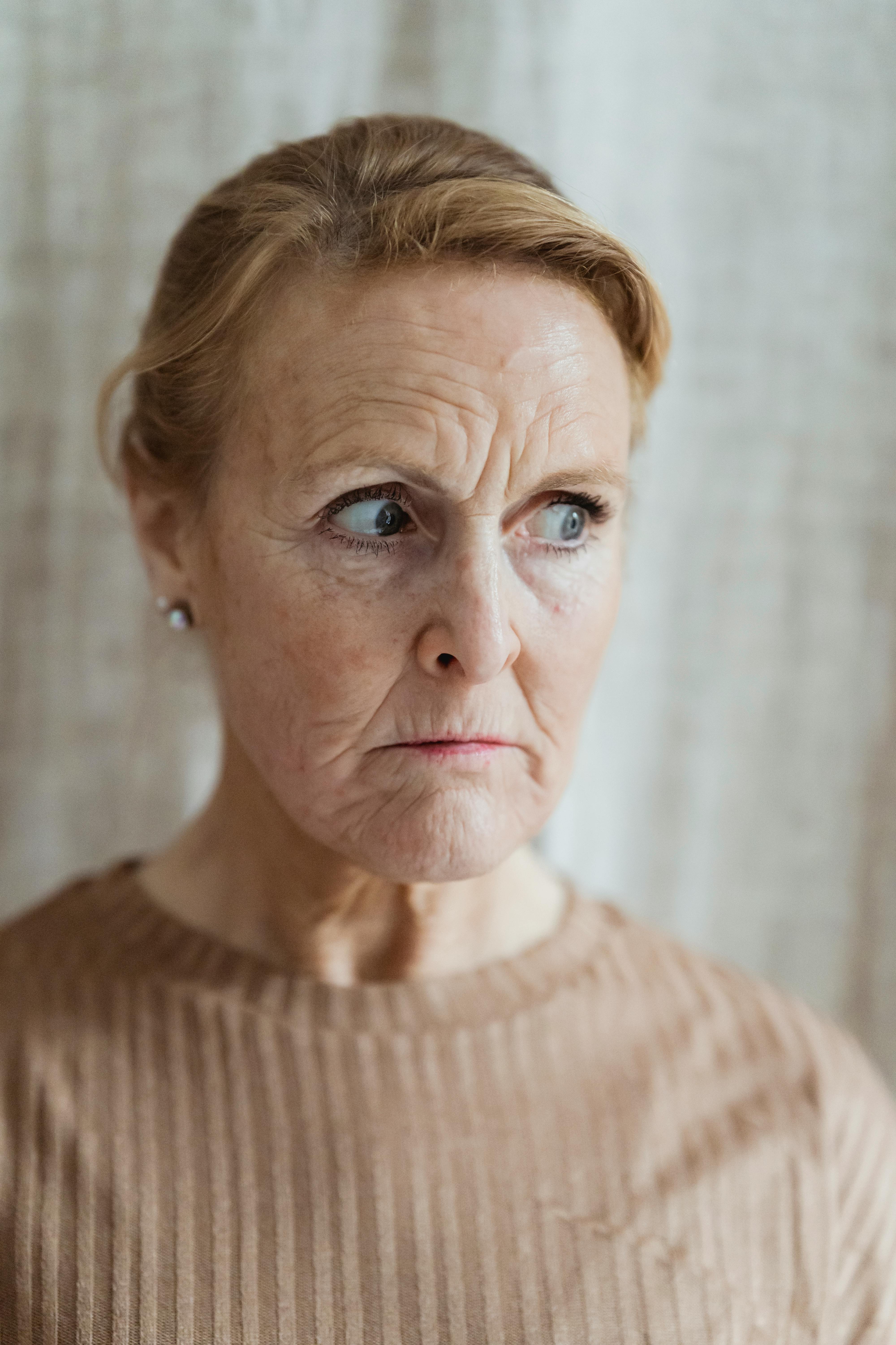 woman in brown shirt looking away