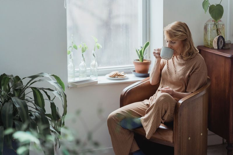 A quiet morning with coffee in a plant-filled room — photo by Teona Swift on Pexels
