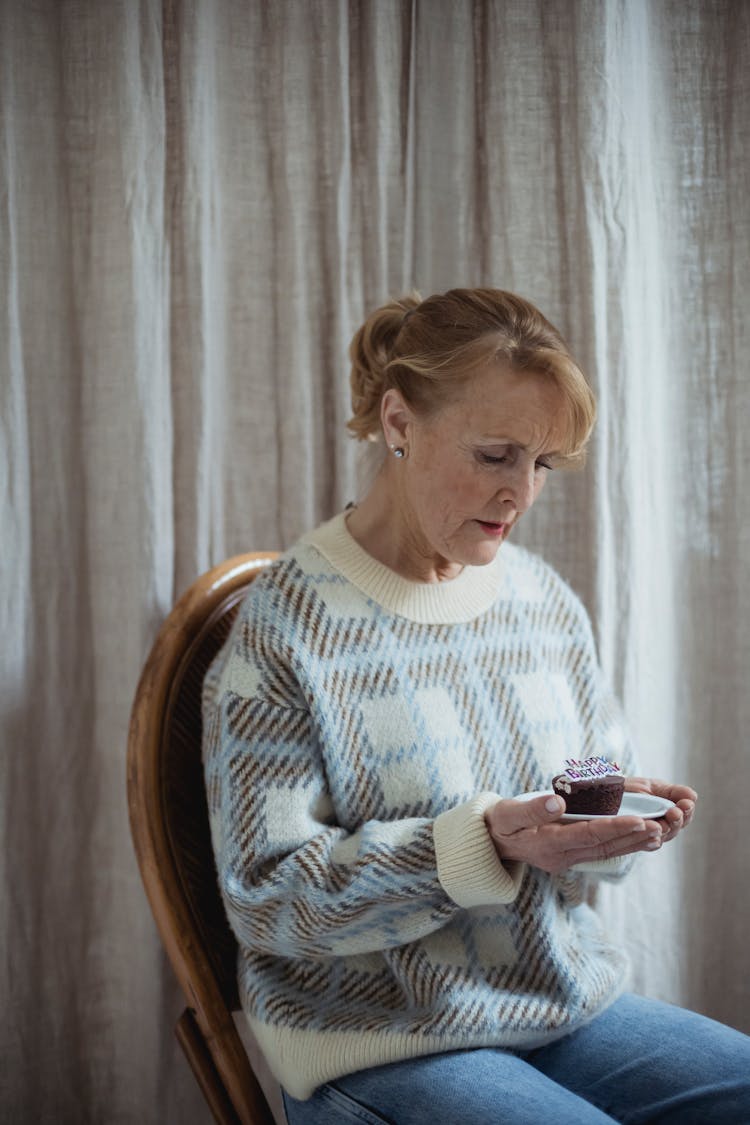 Serious Mature Woman With Birthday Cupcake