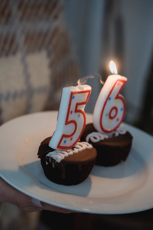 Burning candles on birthday cupcakes