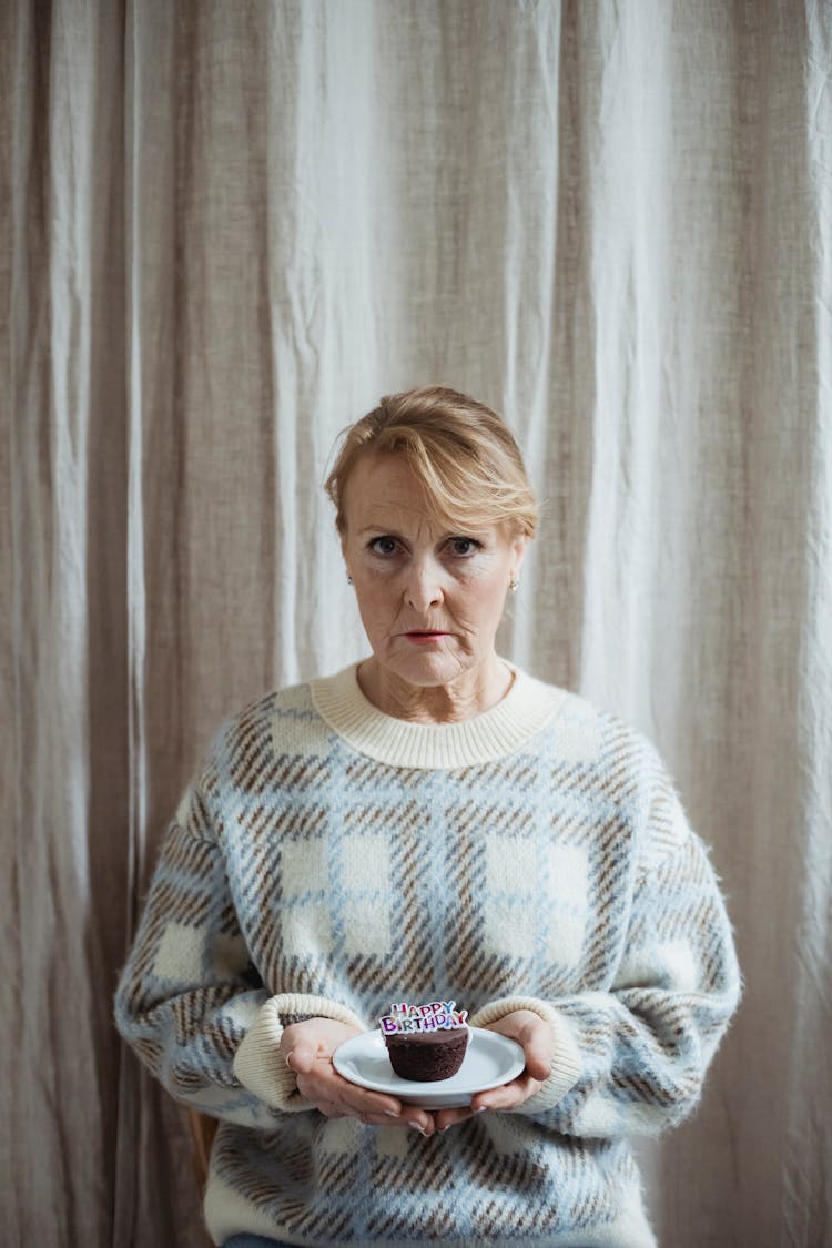 Serious Woman With Cupcake On Birthday