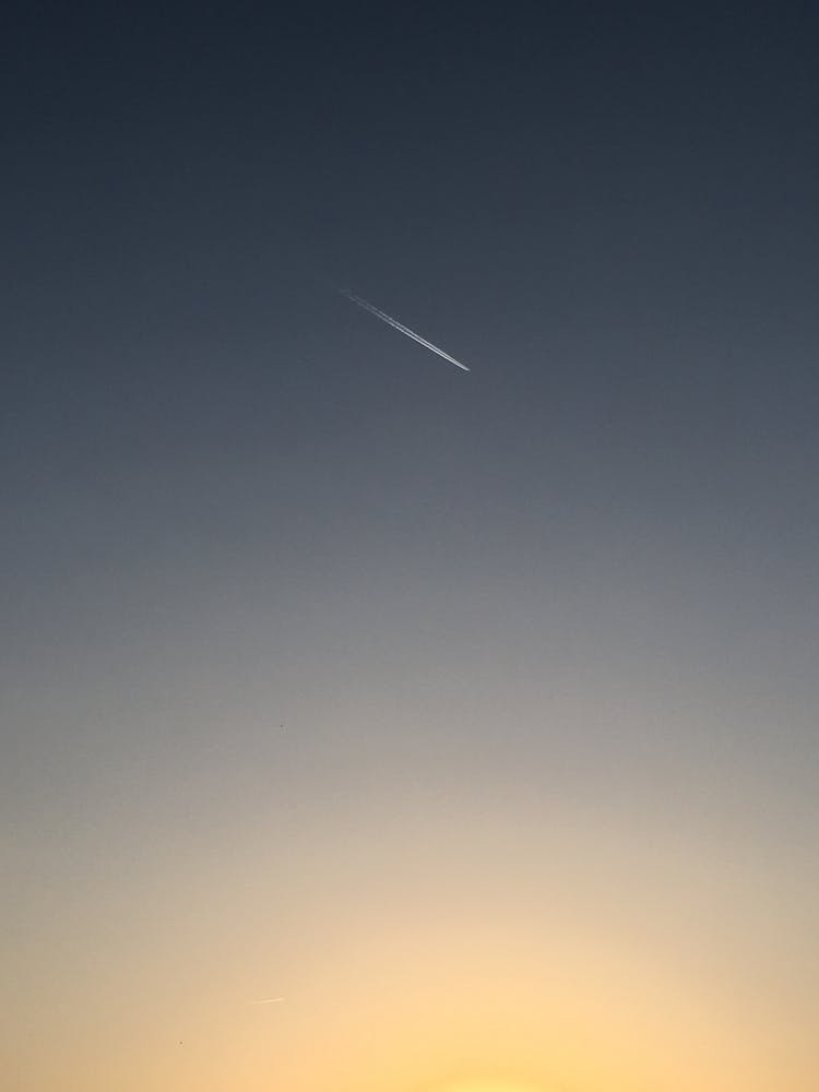 Plane With A Vapour Trail Behind 