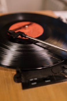 Detailed view of a classic turntable playing a vinyl record, evoking nostalgia and vintage vibes.