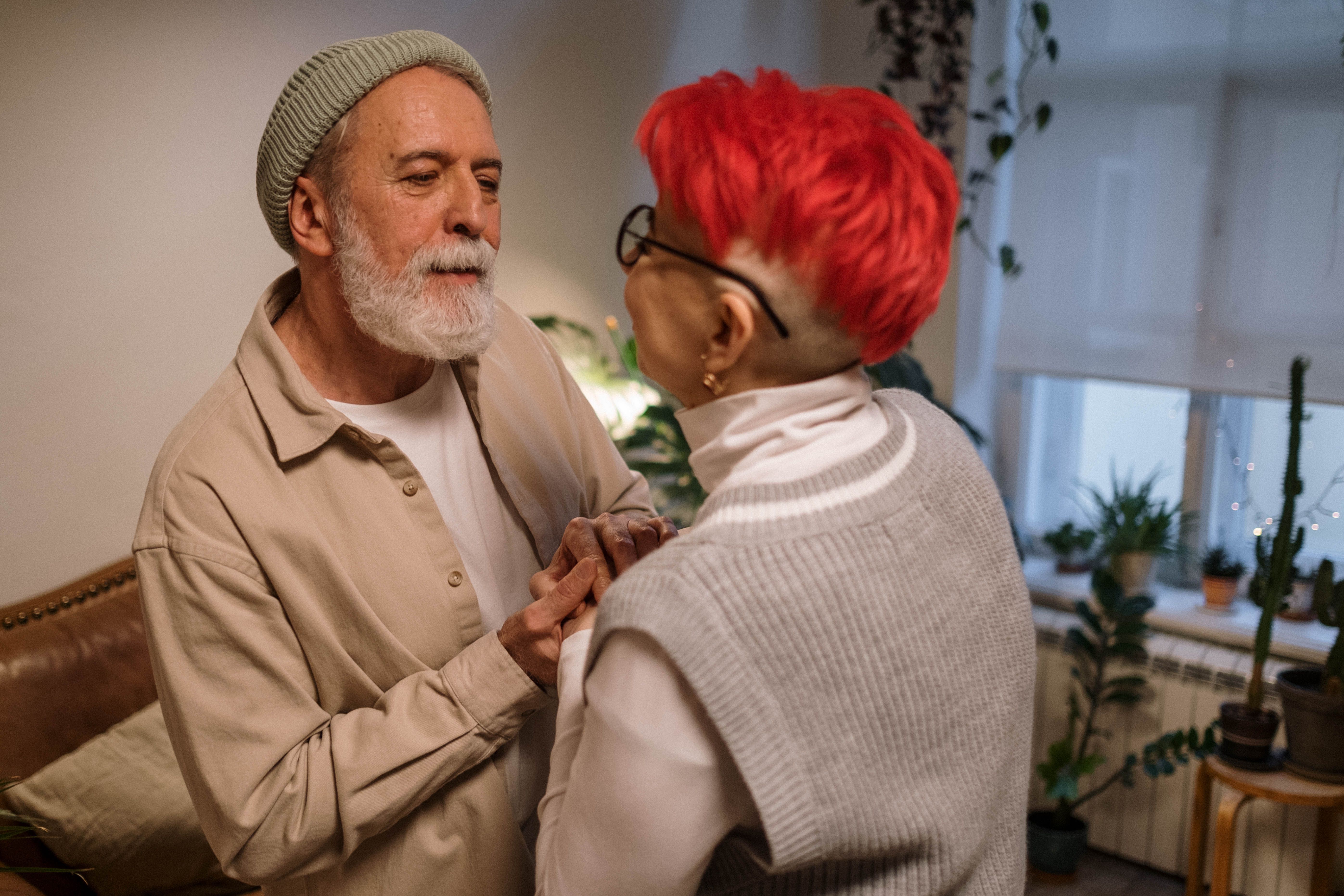 Senior couple sharing a tender moment indoors, exuding warmth and affection.