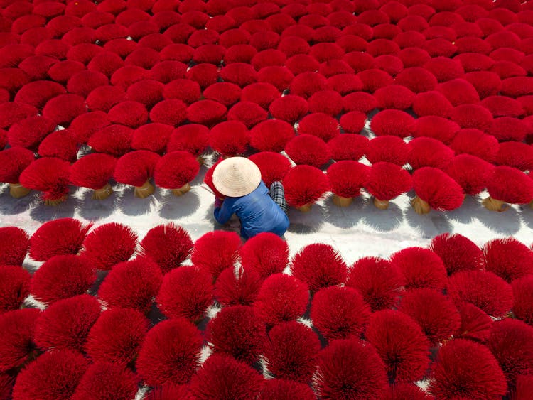 Woman Arranging Incense Sticks In Traditional House