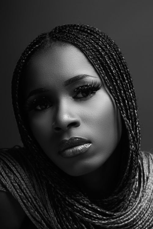 Free Elegant monochrome portrait of a woman with braided hair, capturing beauty and emotion. Stock Photo