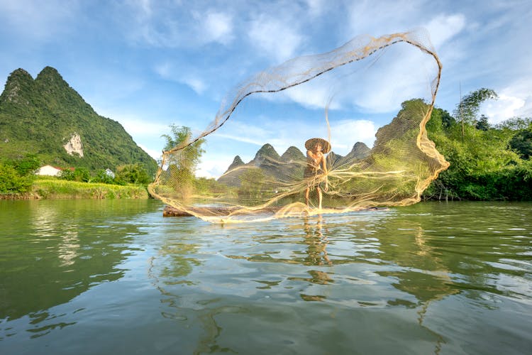 Boy Casting A Fishing Net