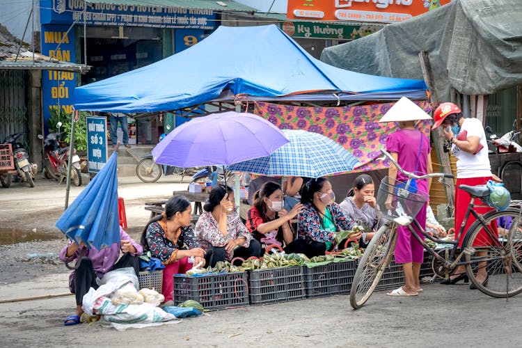 Women Selling Food On A Street Market In Vietnam 