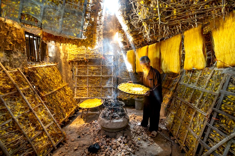 Man Holding A Sift With Fruits