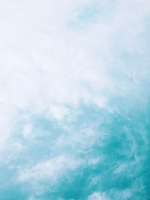 Free Peaceful sky scene featuring soft white clouds against a calming blue background. Stock Photo
