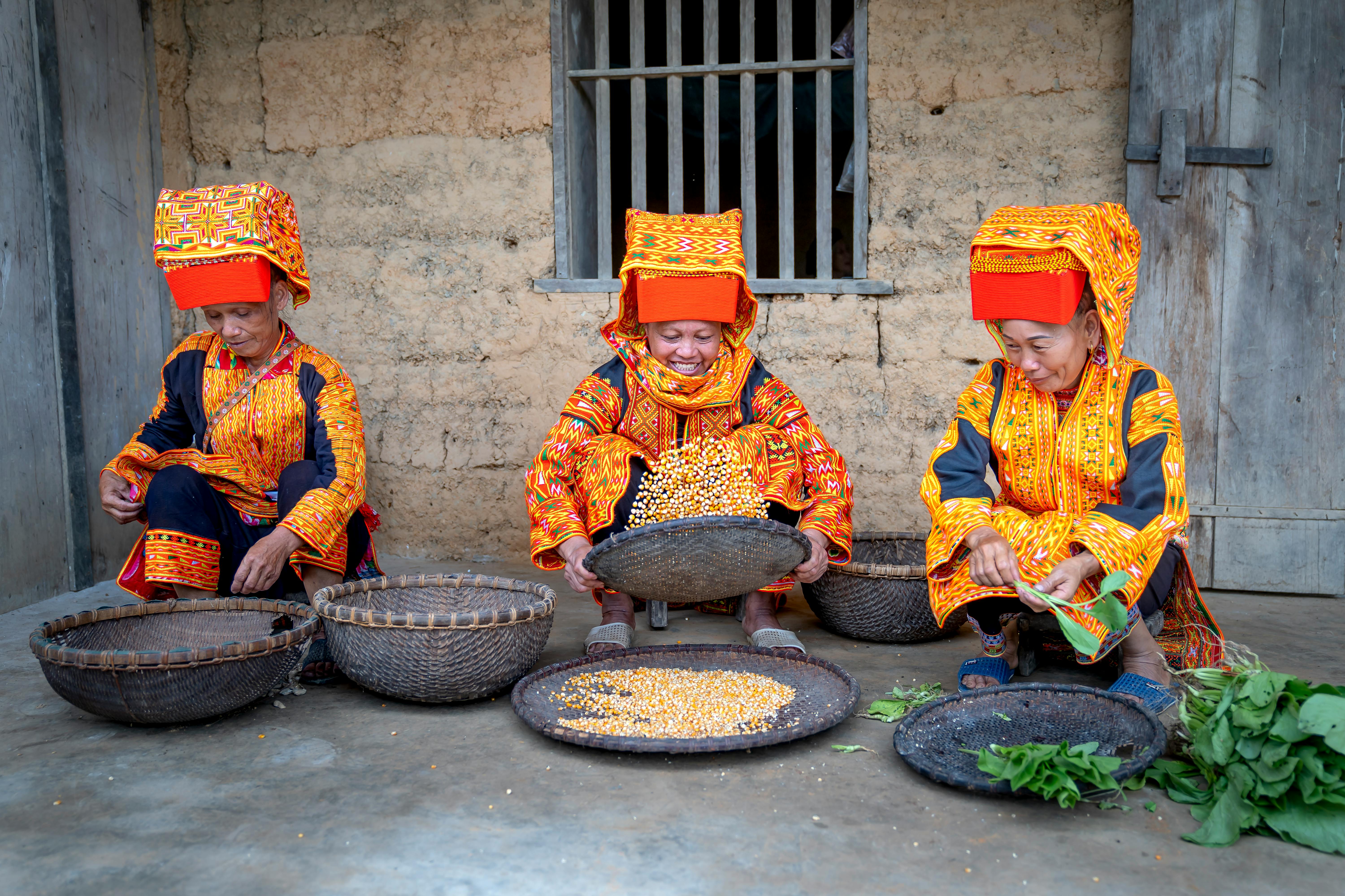 Women Preparing Food in the Yard Wearing Traditional Clothing · Free