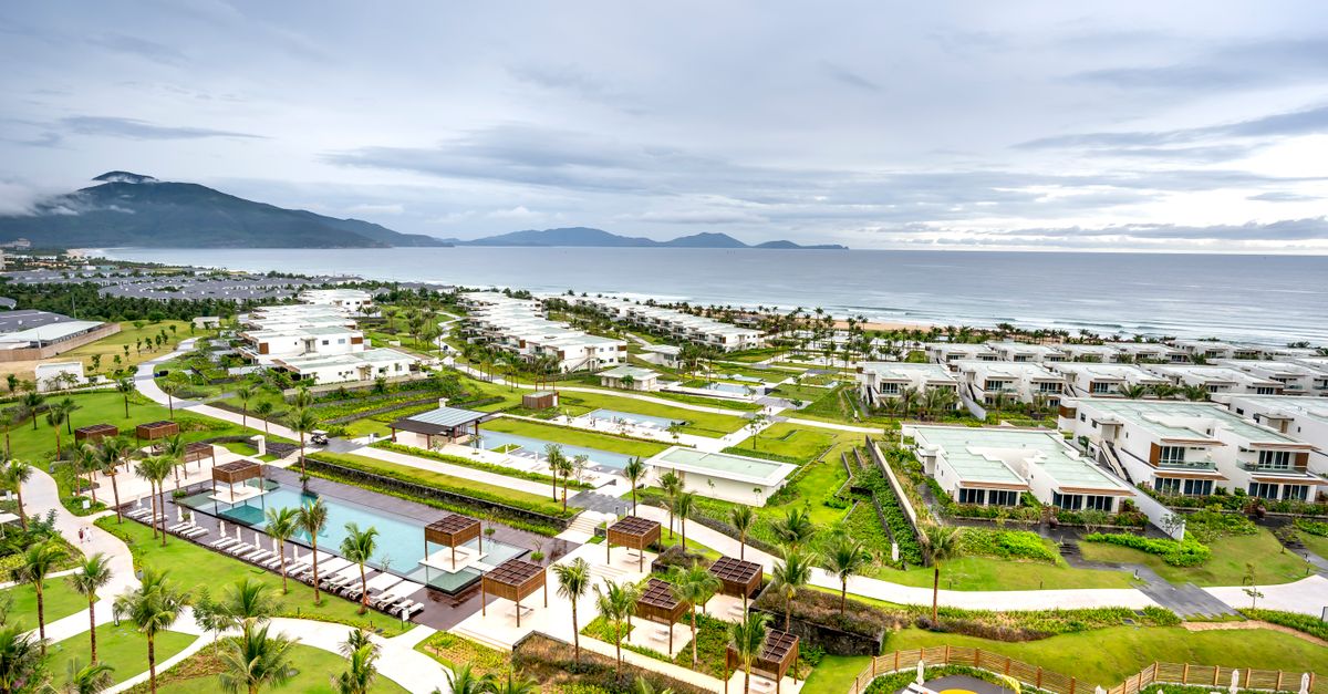 A stunning aerial shot of a coastal resort with luxury residences by the sea.