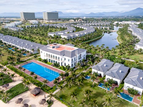 A stunning aerial shot of a luxurious tropical resort with villas and a pool in Vietnam.