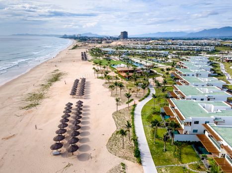 Discover a stunning coastal resort with sandy beach, palm trees, and ocean waves.