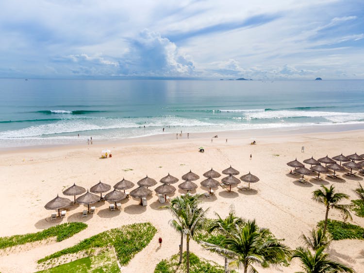 Drone Shot Of People And Umbrellas On A Beach