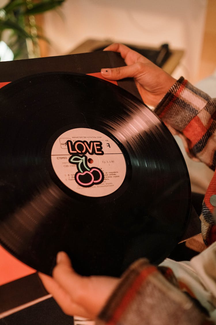 Close-Up Shot Of A Person Holding A Vinyl Record